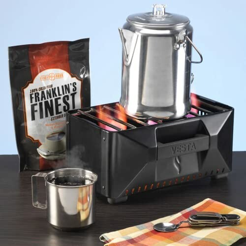 Coffee percolator on portable stove with coffee bag and mug